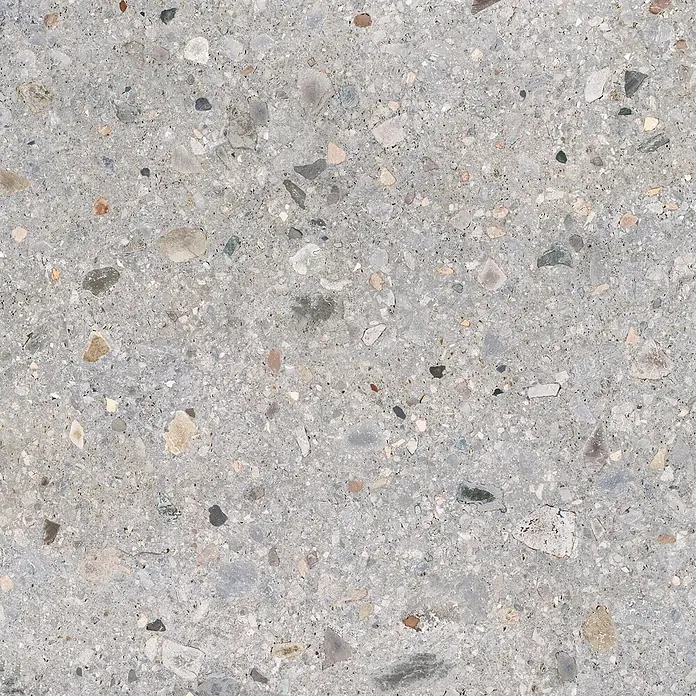 Feinsteinzeug in matter hellgrauer Steinoptik 120x120 - Ital. Fliesen -  - Graue Terrazzoplatte mit bunten Steinsplittern, die eine texturierte Oberfläche zeigt.