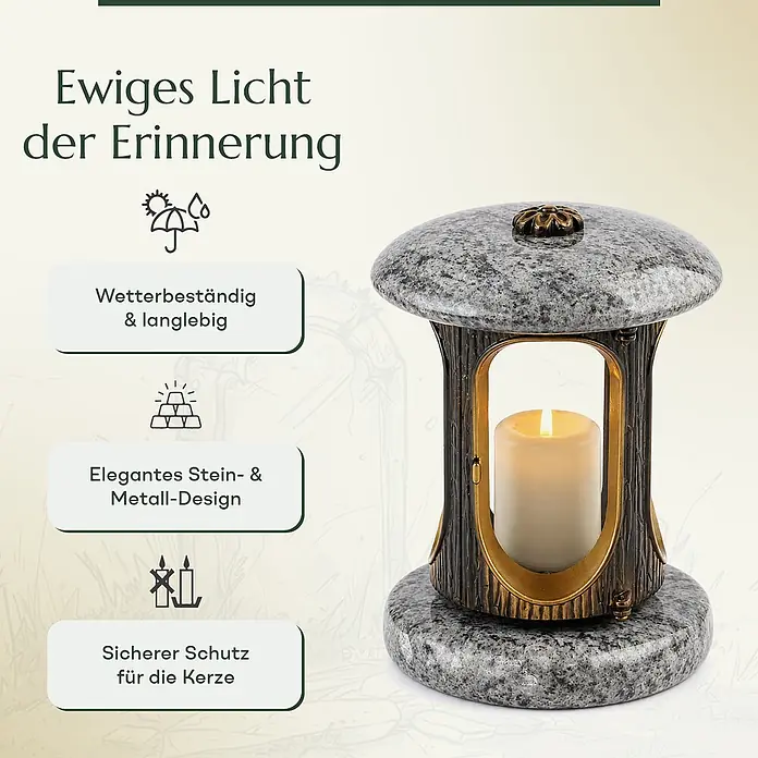 Runde Grablaterne Ø 15 cm, H 22 cm, Granit Orion, Gold-Messing -  - Eine Grablampe aus grau gesprenkeltem Stein und dunklem Metall mit einer brennenden weißen Kerze im Inneren.