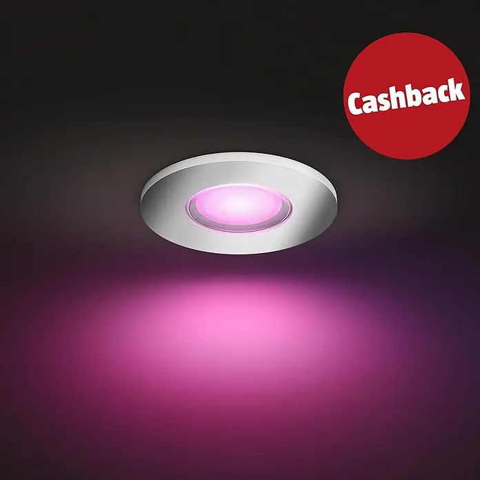 Philips Hue LED-Einbauspot White & Color Ambiance Xamento - RGBW, Durchmesser: 9,4 cm, Silber - Silberner Einbaustrahler mit texturierter Mitte, der pinkes Licht in den dunklen Raum abgibt, mit einem roten 'Cashback'-Kreis.