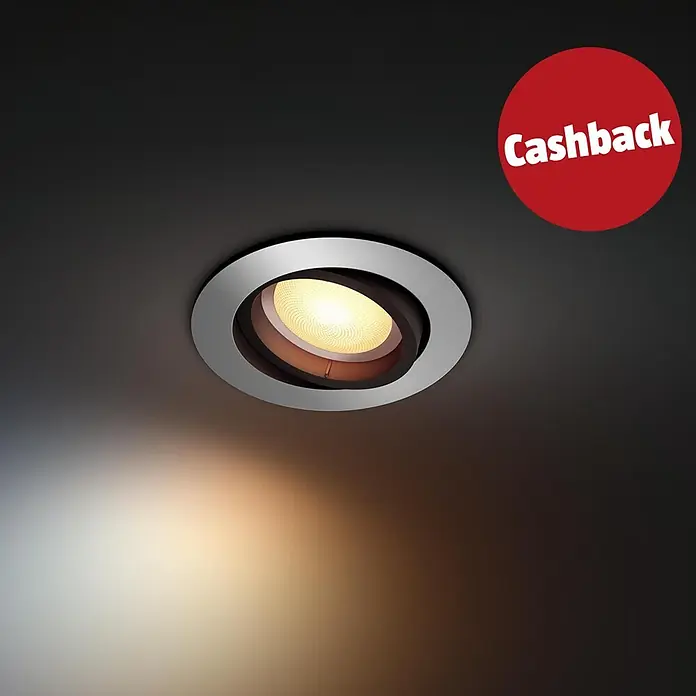 Philips Hue LED-Einbauspot White Ambience Recessed Milliskin - 4,2 W, Ø x H: 9 x 10 cm, Alu, 1 Stk., Kaltweiß - Silberner Einbaustrahler in dunkler Decke, der warmes Licht abgibt, mit rotem 'Cashback'-Abzeichen.
