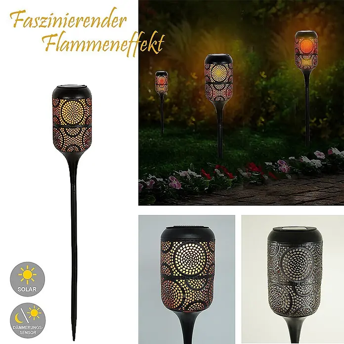 LED Solar-Wegeleuchte mit Flammeneffekt -  - Schwarze Solar-Gartenfackel aus Metall mit dekorativen Aussparungen und Flammeneffekt, beleuchtet einen Gartenweg bei Nacht.