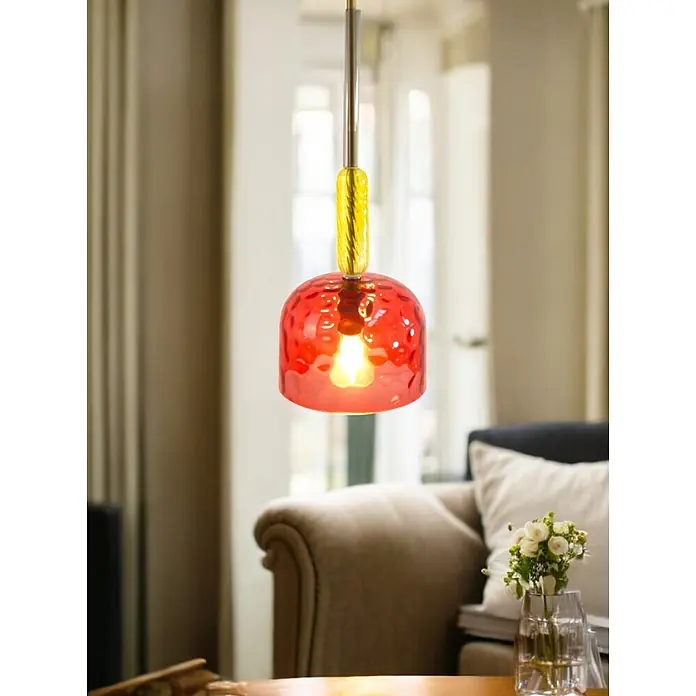 Pendelleuchte AYLA Glasschirm rot-gelb -  - Rote Glas-Pendelleuchte mit gelbem Twisted-Detail, beleuchtet ein Wohnzimmer.