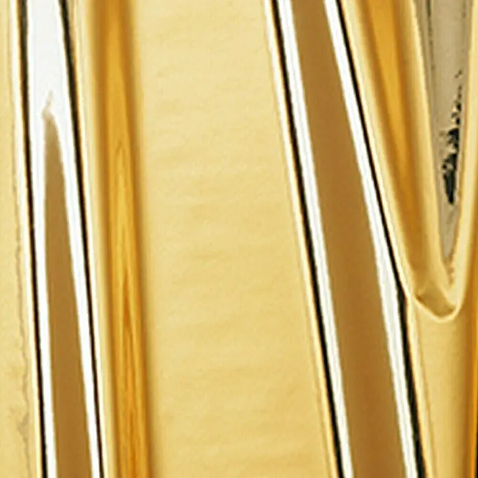 D-c-fix Metalleffektfolie Metallic Hochglanz - 150 x 45 cm, Gold, Selbstklebend - Nahaufnahme eines glänzenden, goldenen Objekts mit Lichtreflexionen und Texturen.