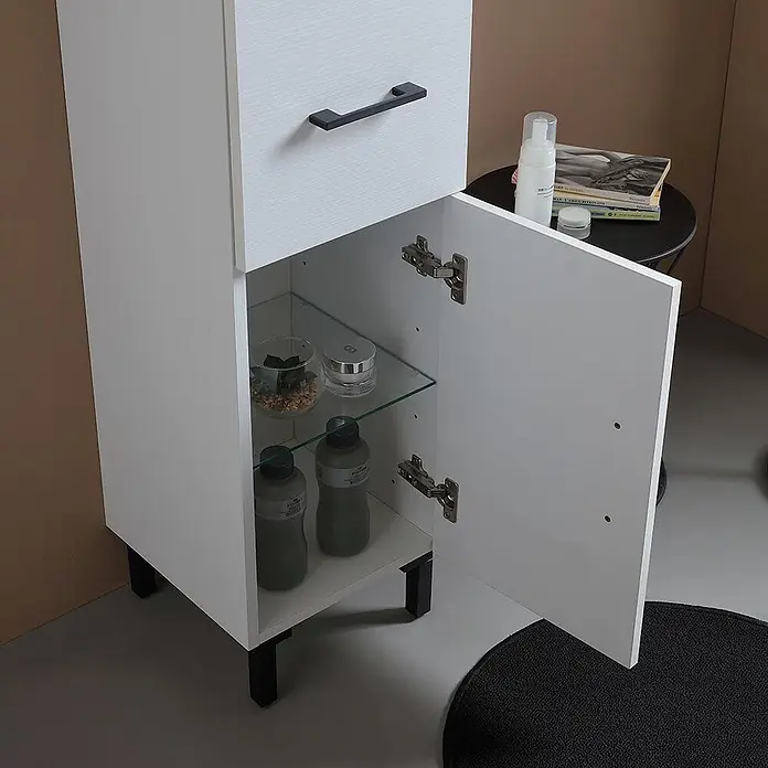 KV Badezimmerschrank hoch, weiß Export, reversibel mit Türen, Schublade und -  - Weißer hoher Badezimmerschrank mit schwarzem Griff, einer Schublade und offenem Schrankfach mit Glasboden und Pflegeprodukten. Er hat schwarze Beine.