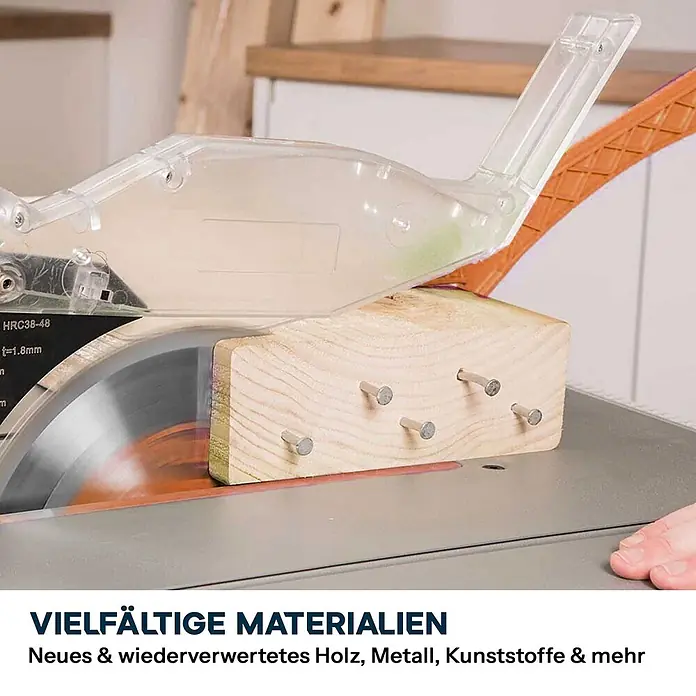 Evolution R255MTS 255 mm Tischsäge mit TCT-Multi-Material-Sägeblatt -  - Tischkreissäge schneidet genageltes Holzstück unter durchsichtigem Schutz, zeigt Materialvielfalt.