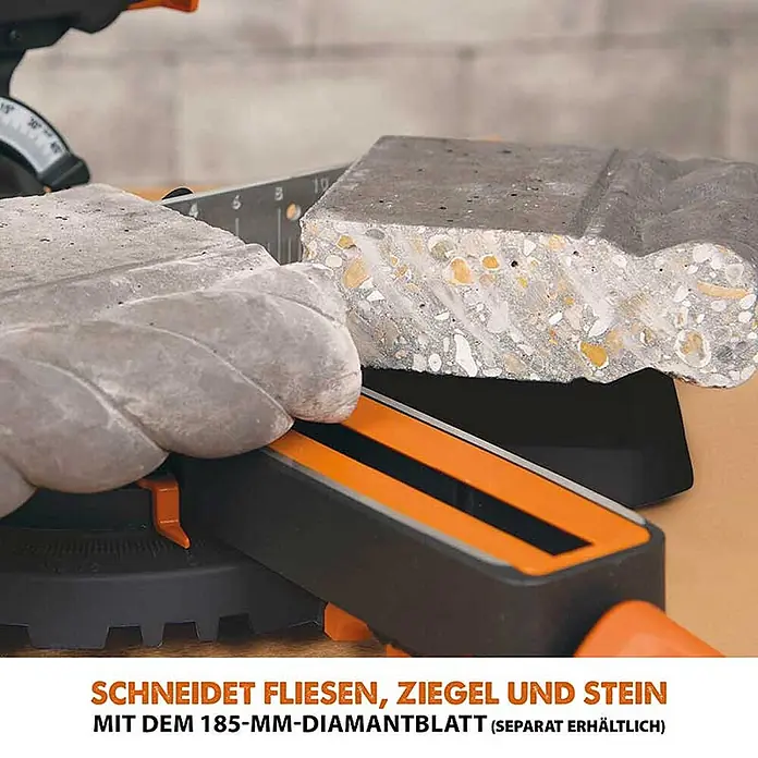 Evolution R185SMS+ Zug-Kapp- und Gehrungssäge 185 mm, TCT-Blatt -  - Orange-schwarze Gehrungssäge schneidet einen Betonblock. Schneidet Fliesen, Ziegel und Stein mit Diamantblatt.