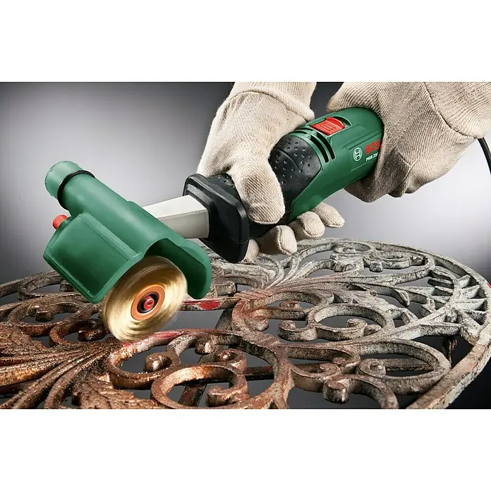 Bosch Bürste - Vermessingt - Der Bosch PRR 250 ES Farbabtrag-Roller entfernt mühelos Rost von einem verzierten Tisch.