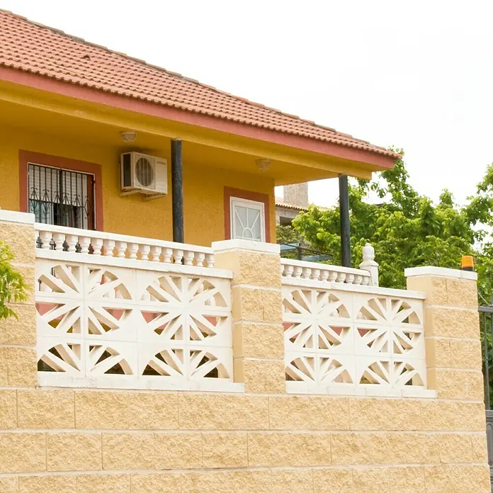 Celosía de pared Abanico - 40 x 20 cm, Blanco - Primer plano de una casa amarilla con techo naranja y una valla decorativa, que realza el carácter único de la casa.