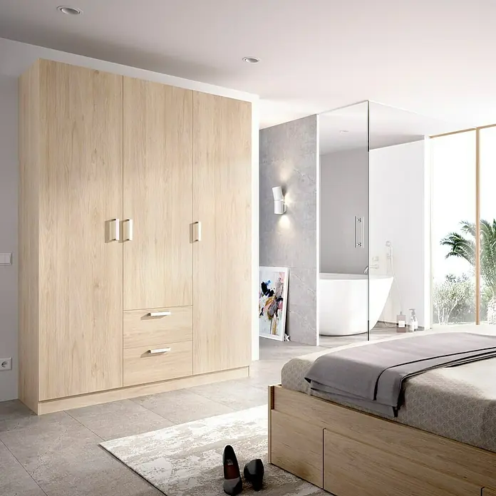 Dekit Armario para ropa Maxi - L x An x Al: 52 x 150 x 215 cm, Roble, Número de puertas: 3 ud. - Imagen de un armario de madera clara con múltiples puertas y cajones en un dormitorio moderno.