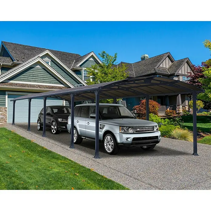 Palram – Canopia Carport Arcadia - Medidas ext. (An x Pr): 3,59 x 10,77 m, Carport doble, Gris - Cochera cubierta con dos coches aparcados en una entrada pavimentada frente a una casa. Proporciona protección contra los elementos.