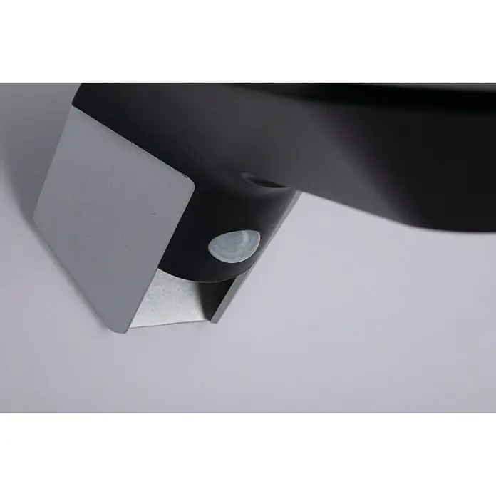 Paulmann Soley Solar-Außenwandleuchte - 1,2 W, L x B x H: 24 x 10,4 x 10 cm, Anthrazit, IP44 - Nahaufnahme einer schwarzen Außenleuchte mit Bewegungssensor und silberner Halterung, die an einer weißen Wand befestigt ist.