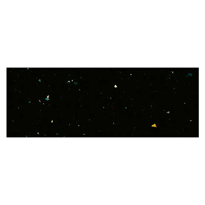 Maderas Daganzo Canto para encimera Fantasia Blister - Negro, 650 x 45 mm - Primer plano de una encimera negra con motas de colores, destacando un diseño de cocina elegante y moderno.