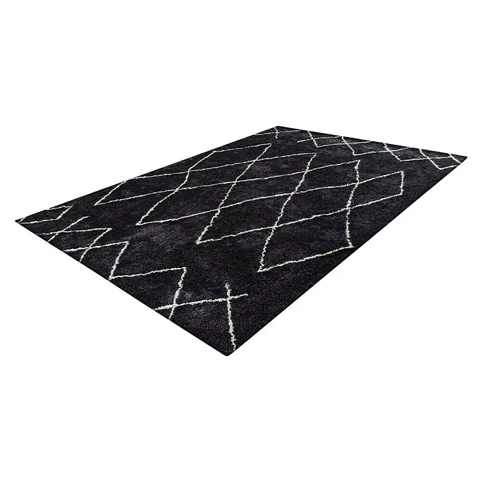 Kayoom Hochflorteppich Orlando 425 - Anthrazit, 230 x 160 cm - Ein stilvoller, schwarzer Teppich mit einem markanten, weißen Zickzackmuster, der jedem Raum eine moderne Note verleiht und optisch aufwertet.
