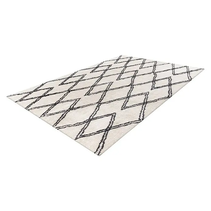 Kayoom Hochflorteppich Orlando 325 - Elfenbein, 290 x 200 cm - Ein cremefarbener Teppich mit einem schwarzen geometrischen Zickzackmuster auf einem schwarzen Hintergrund.