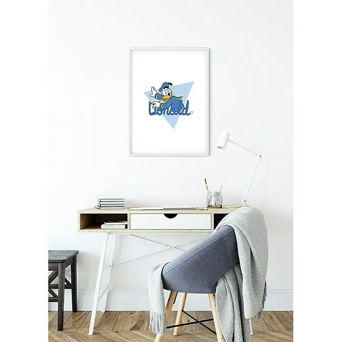 Komar Disney Edition 4 Poster Donald Duck Triangle - Disney, B x H: 40 x 50 cm - Ein gerahmtes Donald Duck-Poster hängt an der Wand über einem Schreibtisch mit einer Lampe und einem Stuhl.