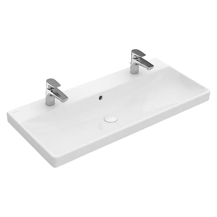 Villeroy & Boch Avento Doppelwaschtisch - 100 x 47 cm, Ohne Spezialglasur, Hahnloch: Mitte, Mit Überlauf, Weiß - Das Bild zeigt ein modernes, rechteckiges Waschbecken mit zwei eleganten Chromarmaturen, das eine stilvolle Ergänzung für jedes Badezimmer darstellt.