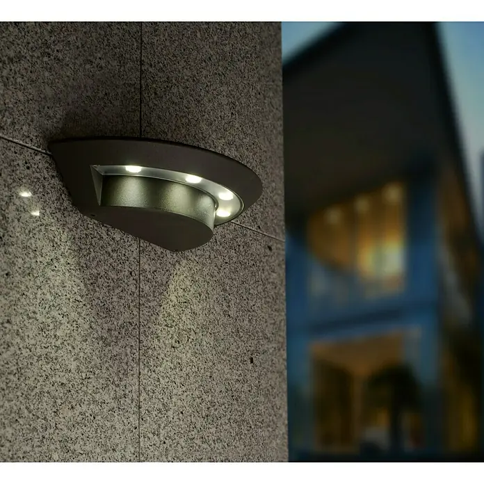 Lutec Aplique LED Ghost - 7 W, 220 V - 240 V, IP54 - Moderna lámpara de pared con iluminación LED montada en una pared de piedra gris para exteriores.