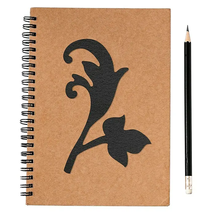 Vinilo de pared Barroco 3 - Negro, Textil - Cuaderno con diseño floral y lápiz. El cuaderno de espiral tiene una cubierta marrón con un delicado recorte floral negro.