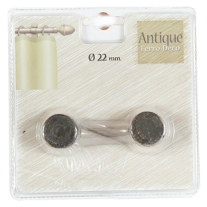 Tapa final tapón Antique negro oro - 2 ud. - Primer plano del embalaje con dos abrazaderas para cortinas "Antique Ferro-Déco" con aspecto antiguo, unidas por un puente.