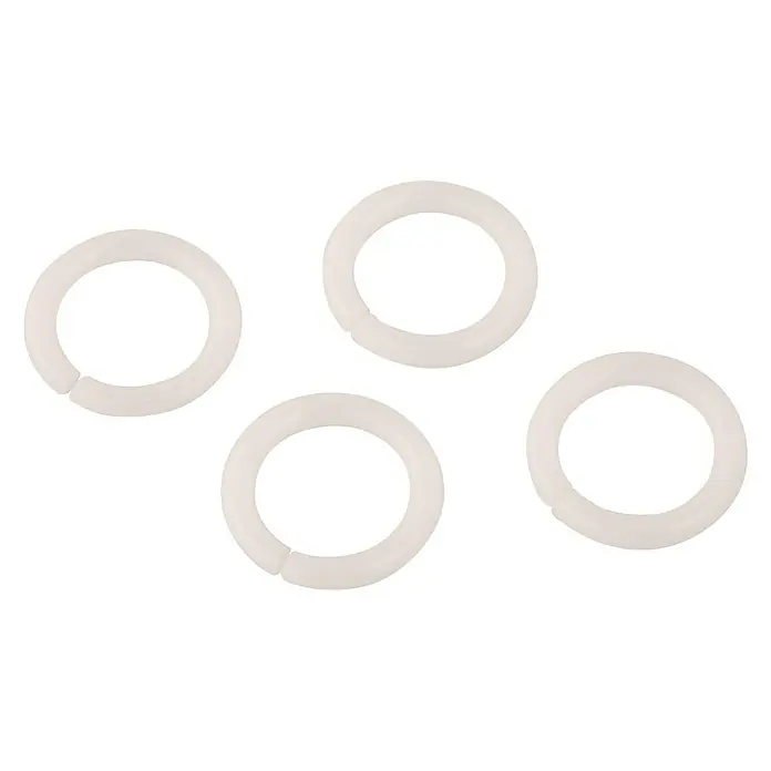 Klemmring - ¾″, Geeignet für: Rohrausläufe - Nahaufnahme von vier weißen, runden Spielzeuggliedern, die auf einem schwarzen Hintergrund angeordnet sind, ideal zum Verbinden und Spielen.