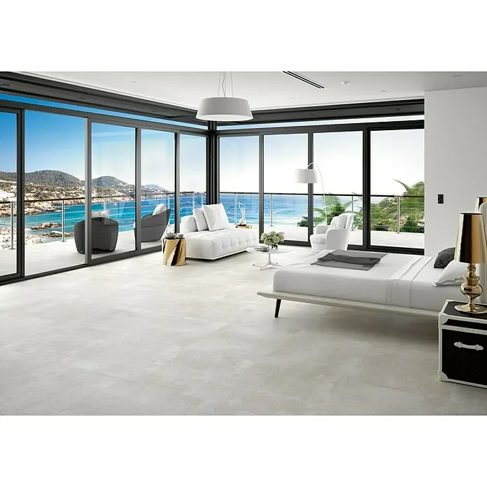 BHS Showroom Pavimento porcelánico Claire - 60 x 60 cm, Gris, Rectificado - Dormitorio luminoso con baldosas de gran formato que ofrece impresionantes vistas a través de ventanas de pared a pared.