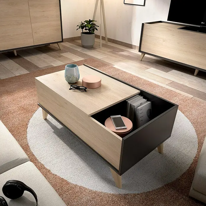 Dekit Mesa auxiliar de jardín Ness - L x An x Al: 60 x 99 x 41 cm, Natural/Grafito - Una mesa de centro moderna con un cajón que contiene libros y un smartphone. La mesa está hecha de madera clara y negro.