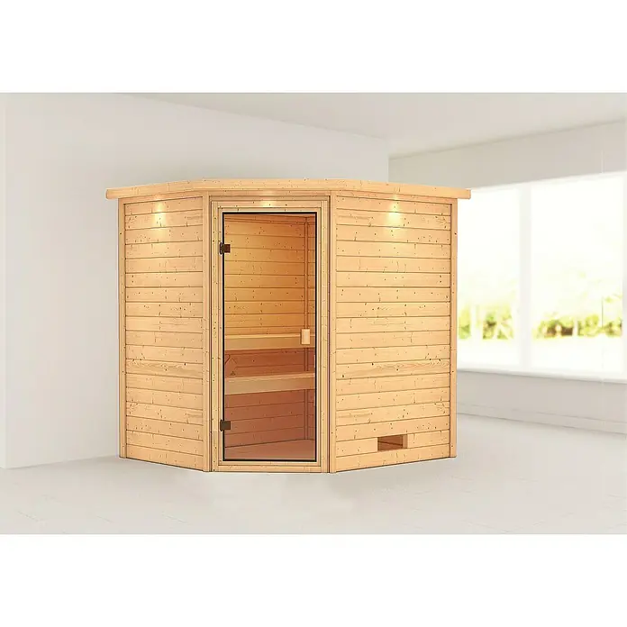 Karibu Massivholzsauna Elea - Mit Dachkranz und Beleuchtung, L x B x H: 183 x 223 x 191 cm - Saunakabine aus hellem Holz mit Glastür in einem hellen Raum. Die Sauna hat eine moderne Optik und lädt zum Entspannen ein.