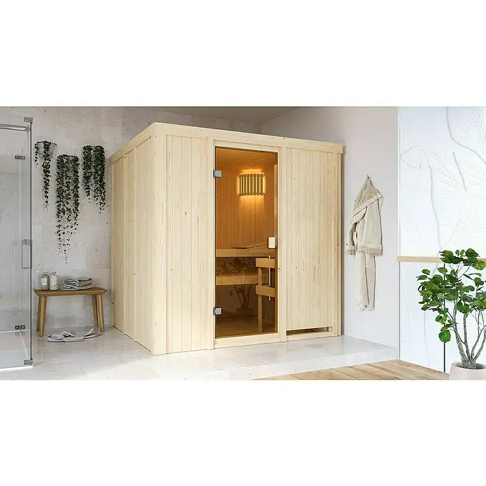 Karibu Elementsauna Tromsoe - L x B x H: 178 x 196 x 198 cm, Ohne Ofen - Ein modernes Badezimmer mit einer hellen Holzsauna, die durch eine Glastür Einblick bietet und eine entspannende Atmosphäre verspricht.