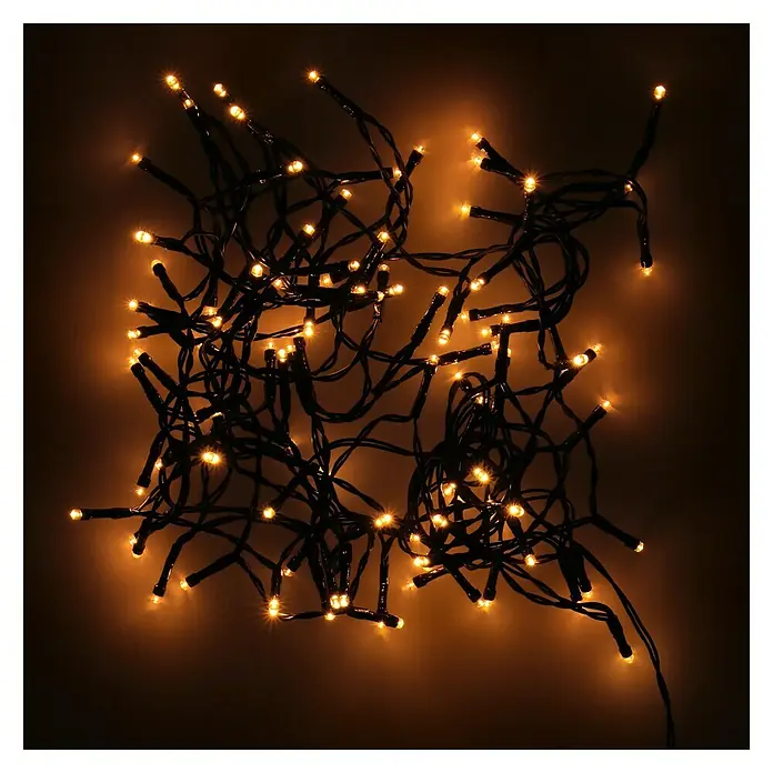 Guirnalda luminosa LED - Para exterior, 7,2 m, Color de luz: Blanco cálido, Número de bombillas: 96 ud., Funciona con pilas - Imagen de una cadena de luces blancas cálidas, creando un ambiente acogedor. Ideal para decoraciones y ocasiones festivas.