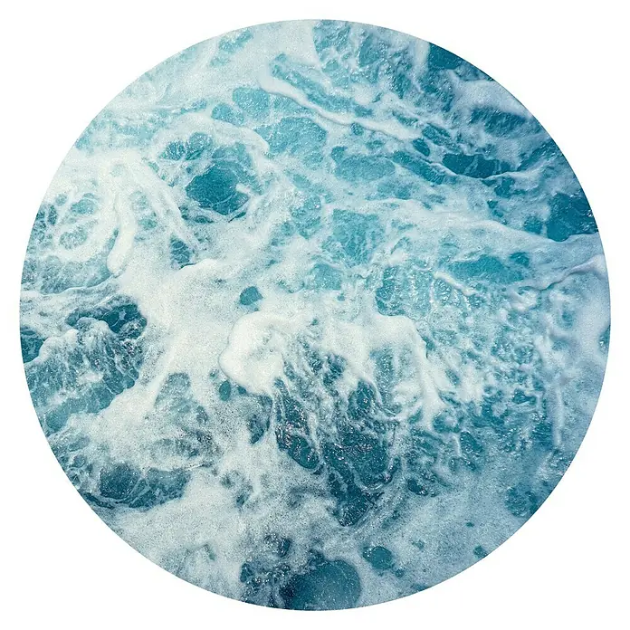 Komar Dots Fototapete rund Ocean Twist - 125 cm, Selbstklebend - Nahaufnahme des schäumenden, türkisfarbenen Wassers, das eine wirbelnde, kreisförmige Textur erzeugt.
