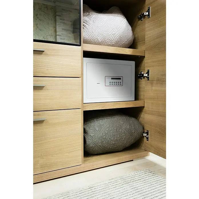 Arregui Caja fuerte Forma Evolution 150020 - L x An x Al: 250 x 350 x 250 mm, Cerradura de combinación electrónica, Blanco - Armario empotrado con caja fuerte blanca, cojines y cajones con diseño de madera clara, ideal para guardar objetos de valor y textiles.