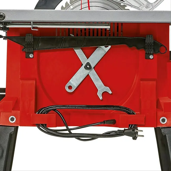 Einhell Sierra circular de mesa TC-TS 2225 U - 2.200 W, Diámetro hoja de sierra: 254 mm, Profundidad de corte a 90 °: 80 mm - Vista detallada de una sierra de mesa Einhell con herramientas y cable de alimentación. El dispositivo es rojo y negro.