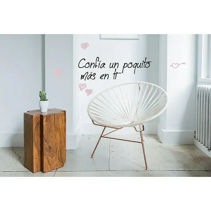 Vinilo de pared Confía - Plástico - Escena decorativa con una elegante silla de cuerda blanca con patas de cobre y una mesa auxiliar de madera rústica con un cactus.
