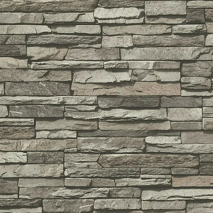 A.S. Création Elements Vliestapete Bruchsteinmauer - Grau/Creme, Steinoptik, 10,05 x 0,53 m - Nahaufnahme einer Wandverkleidung aus grauem Naturstein mit unregelmäßiger Textur für eine rustikale und elegante Innenraumgestaltung.
