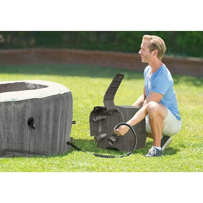 Intex Pure Spa Hidromasaje móvil Greywood Deluxe - Ø x Al: 196 x 71 cm, Gris/Blanco, 795 l - Un hombre conecta una bomba de filtro para jacuzzi portátil a un jacuzzi inflable. El producto está diseñado para el mantenimiento del agua.