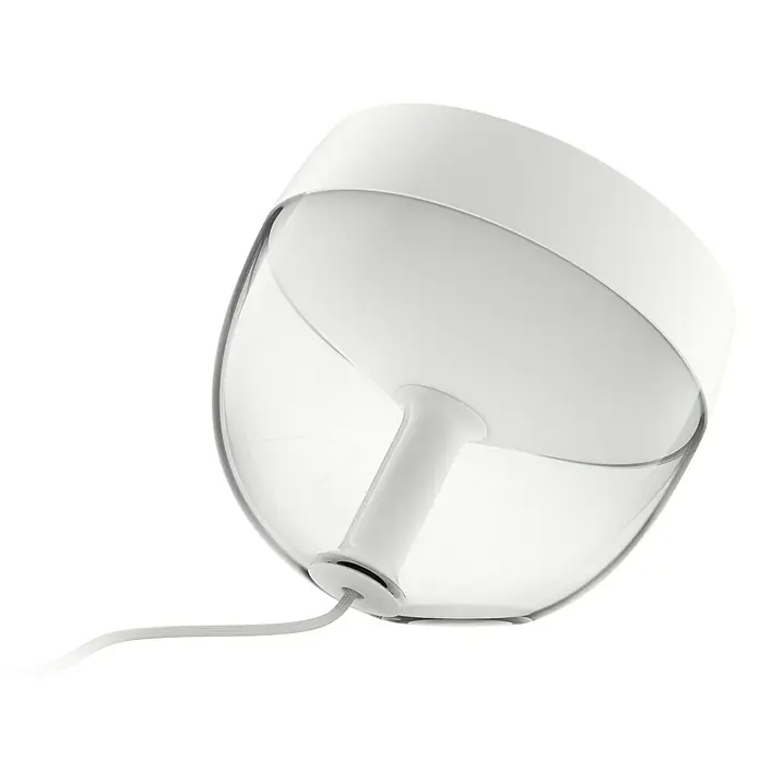 Philips Hue LED-Tischleuchte Iris - Weiß/Transparent, Höhe: 19,4 cm - Nahaufnahme einer modernen, weißen Tischleuchte mit klarem Lampenschirm auf schwarzem Hintergrund.