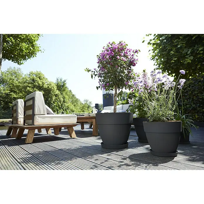 Elho Vibia Campana Maceta para planta Vibia Campana - Dimensiones externas (Ø x Al): 47 x 40,4 cm, Plástico, Antracita - Macetas grises para plantas sobre una terraza de madera con plantas. Las macetas son de material robusto y ofrecen espacio para diversas plantas.
