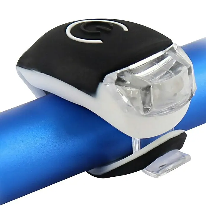 T'nB Linterna para bicicletas - Blanco - Primer plano de una luz de bicicleta blanca y negra unida a un manillar azul.