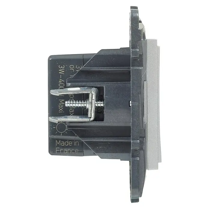Legrand Niloé Step Regulador luminoso + Pulsador - Aluminio, Plástico, Instalar - Vista lateral de un interruptor de luz de plástico gris con terminal de tornillo y marcas "Made in France" y "3W-400W Maxi".