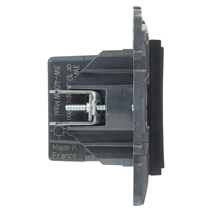 Legrand Niloé Step Regulador luminoso + Pulsador - Antracita, Plástico, Instalar - Vista lateral de un interruptor gris, mostrando detalles como el tornillo y las inscripciones que indican el lugar y la potencia.
