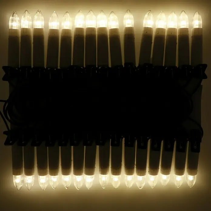 Tween Light Velas de Navidad LED - 14,55 m, Blanco, Color de luz: Blanco cálido, 30 ud., IP20 - Imagen de una cadena de luces con forma de vela, emitiendo un brillo cálido y acogedor. Ideal para decoraciones festivas.