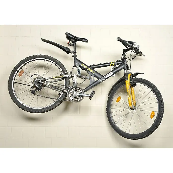 UBB Schienenkonsole - Profil: 38/40, Länge: 440 mm - Wandmontiertes schwarzes Mountainbike mit gelber Federung. Das Fahrrad ist an einer hellen Wand befestigt und verfügt über einen gefederten Rahmen.