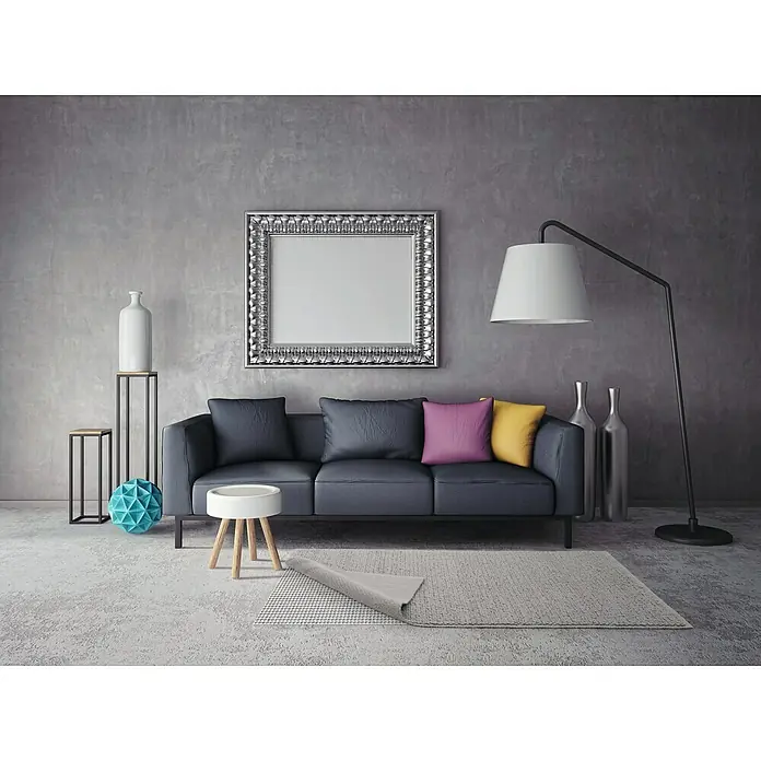 D-c-fix Protección antideslizante Loom - 120 x 60 cm - Elegante sala de estar con sofá gris, cojines decorativos, lámpara y decoración elegante frente a una pared gris.