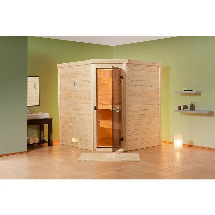Finnwood Massivholzsauna Bjoern 2 - Elektroofen, Steuerung Ofen: Integriert, L x B x H: 178 x 195 x 203 cm - Eine Ecksauna mit Holzwänden und Glastür steht in einem Badezimmer und bietet Entspannung und Wohlbefinden in den eigenen vier Wänden.