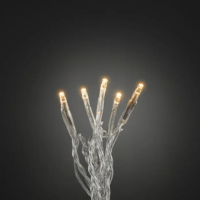 Konstsmide LED-Lichterkette - Innen, Lichtfarbe: Bernstein, Anzahl Leuchtmittel: 50 Stk., Netzbetrieben - Nahaufnahme von dekorativen, warmweißen LED-Lichterkette, die ein gemütliches Ambiente für festliche Anlässe schafft.