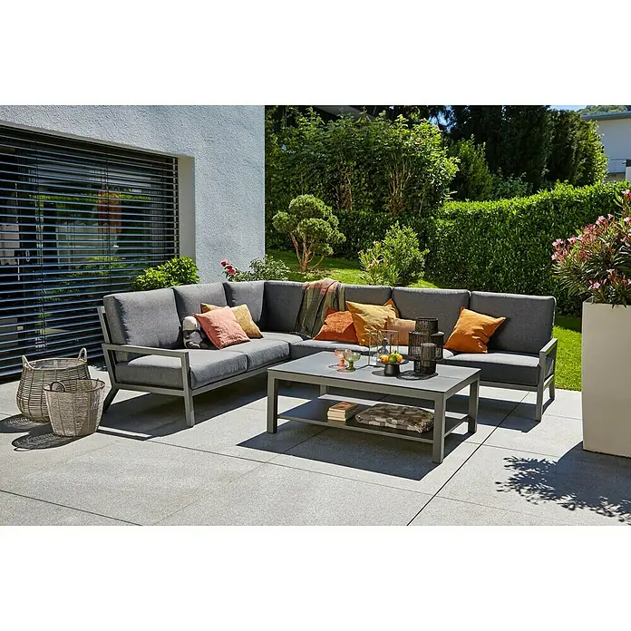 Sunfun Maja Sofá de conjunto - Aluminio, Antracita - Un salón de jardín gris con una mesa de centro y cojines coloridos en un patio, ideal para relajarse al aire libre.