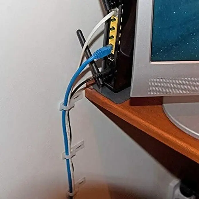 Stanley Grapadora de cables STHT6-70989 - Abrazadera de cables - Un primer plano muestra cables ordenados en una pared utilizando clips de cable, demostrando una gestión limpia de los cables.