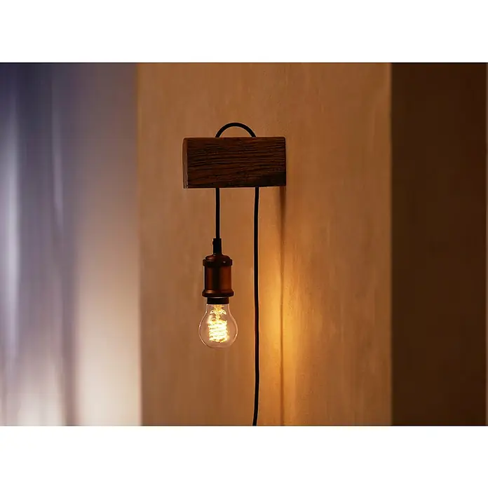 Philips Hue Bombilla LED inteligente Filamento blanco - E27, Intensidad regulable, Blanco cálido, 550 lm, 7 W, Denominación de la lámpara: A60 - Lámpara de pared con base de madera rústica y bombilla expuesta que emite una cálida luz.