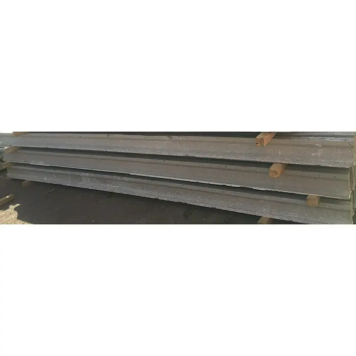 BHS Valencia Base de hormigón Viga T18 - Largo: 6 m - Foto de paneles de hormigón apilados con soportes de madera, almacenados para proyectos de construcción. Ideal para estructuras robustas.