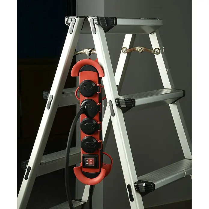 Base de enchufe múltiple - x 4, Negro/Rojo, Longitud del cable: 4 m, IP44, Con interruptor - Una regleta roja con interruptor colgada de una escalera plateada. Práctica fuente de alimentación para trabajar en altura.